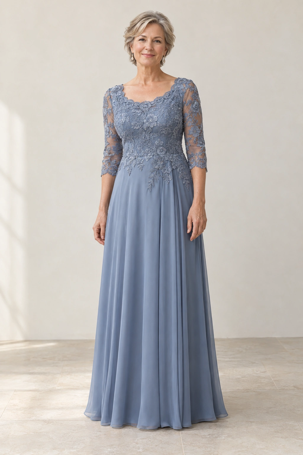 Dusty blue lace and chiffon mother of the bride dress with three-quarter sleeves